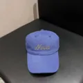 Detailed view of a blue cotton baseball cap featuring embroidered Mood text on the front. - Adjustable / Blue