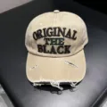 Close-up detail of vintage distressed beige baseball cap with black embroidered text. - Adjustable / Khaki