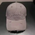 Detail view of the American retro distressed baseball cap in grey with front letter embroidery. - Gray
