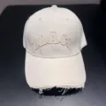 Retro washed baseball hat with distressed brim and embroidered letters for street style wear. - Beige
