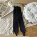 Black knitted stirrup leg warmers for women, cozy winter long socks with textured pattern. - One Size / Black