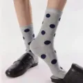 Grey mid-calf socks featuring classic blue polka dot pattern for women, stylish and comfortable. - One Size / Gray