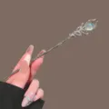 Silver hair stick featuring intricate filigree leaf design and an iridescent gemstone for chic buns. - Phoenix Tail Moonstone-Look / Silver