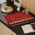 Detail shot of retro grid leather placemat with elegant kitchen decor and cutlery. - Hello Red