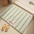 Absorbent bath mat with green and pink stripes and Bonjour text, anti-slip design for bathroom. - Cherry Blossom Salt Soda
