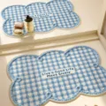 Detailed view of blue and white checkered cloud-shaped bathroom absorbent mat with cozy style. - Blue Sea White Salt