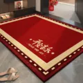 Red festive loop pile entryway floor mat featuring a beige border and auspicious text. - Burning Red Joy