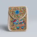 Close-up of bohemian straw phone bag featuring colorful beaded elephant and floral details. - Straw Crossbody Bag No.4