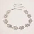 Detailed shot of a vintage silver metal waist chain for women, featuring carved circular links. - Style A3 / Silver