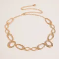 Close-up details of vintage gold metal waist chain with textured oval links and dainty charm. - Style A6 / Gold