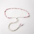 Detail shot of boho pink beaded woven waist cord, elegant casual decorative accessory. - 7 Groups Pink Jade Beads