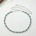 Close-up of elegant women silver waist chain with sparkling green rhinestones and metal links. - Green Rhinestone Belt C
