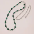 Close-up detail of silver-tone metal waist chain featuring sparkling green crystal stones. - Green Rhinestone Belt D
