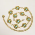 Close-up detail shot of the western style turquoise sunburst concho metal waist chain belt. - Thick Round Turquoise Style / Gold
