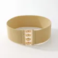 Detailed view of the wide elastic waist belt with gold interlocking metal buckle hardware. - Khaki