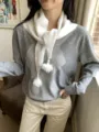 Knitted triangle scarf with beads and tassels for women winter fashion accessory detail view. - White