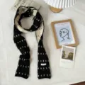 Detailed view of the Korean style contrast knit scarf, showing soft texture and cozy wear. - 180x7cm / Black