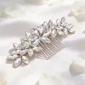Close-up of elegant crystal wedding hair comb with rhinestone leaves for bridal updos. - Silver