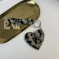 Detailed view of the stylish tortoise shell acetate heart and comb keychain accessory. - Tortoiseshell