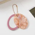 Oval mirror keychain pendant with marbled glitter cover and pink frame, elegant bag accessory. - Peach Shell Pink