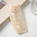 Detailed view of the luxury marble texture curved acetate wide-tooth comb for daily hair styling. - Beige