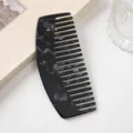 Black marbled acetate wide tooth comb for hair styling, elegant curved design detail view. - Black Gem