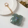Chic four leaf clover keychain with gold chain and mirror acrylic charm for daily bag decor. - Dark Green
