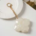 Detailed view of the chic four leaf clover mirror keychain and stylish bag charm accessory. - Pearl White