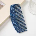 Close-up of blue acetate wide-tooth hair comb showing exquisite marble texture and smooth finish. - Sapphire Blue