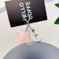 Creative badminton racket keychain detail shot, cute heart comb and shuttlecock pendant decor. - Pink