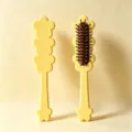 Detail view of the cute yellow floral-shaped hair brush showcasing brown cushion bristles. - 20.8*4.6*3.3 8mm Thickness / Yellow