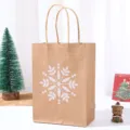 Detail shot of kraft paper Christmas gift bag with white snowflake print and handles. - Snowflake Print (NF-Y009-3) / 15x8x21cm