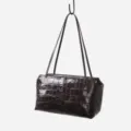 Detail shot of the crocodile embossed genuine leather underarm shoulder bag structure. - Coffee