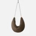 Detailed view of the dark brown suede crescent shoulder bag, highlighting the soft texture. - Moss Green