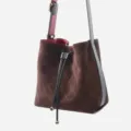Stylish brown suede quilted bucket bag featuring black leather strap and secure drawstring. - Coffee
