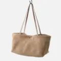 Close-up detail of the minimalist khaki suede tote bag showcasing soft texture and slim straps. - Khaki