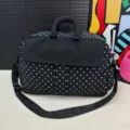 Black polka dot travel bag, lightweight short trip luggage, stylish portable storage design. - Black