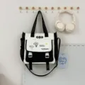Sac cabas en toile noir et blanc avec rabat, boucles doubles et bandoulière réglable. - Sac à main / Noir