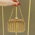 Elegante borsa da sera dorata con strass, chiusura in cristallo e tracolla a catena. - Oro