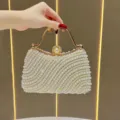 Elegant pearl beaded evening clutch bag with golden handle and diamond lock design. - Off White