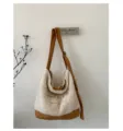 Close-up detail shot of the plush sherpa shoulder bag hanging on wall with warm tones. - Crossbody Type / White