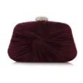 Close-up detail of the elegant wine red pleated evening clutch with rhinestone clasp. - Purple