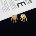 Close-up detail of the gold spider brooch pin, showcasing intricate metallic legs and texture. - Gold Spider (R103) / Gold