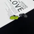 Close-up detail of cute green frog couple enamel pin, showing front design and back clasp. - Interacting Frogs Style (R842)