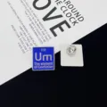 Close-up detail shot of the creative chemistry element pin, showing front and clear back view. - Um The Element of Confusion(R419) / Blue