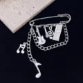 Detailed close-up view of gothic punk style music symbol brooch with instrument charms. - Gothic Punk Music Theme Style (R221)