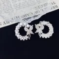 Detailed close-up of pearl and rhinestone butterfly wreath brooch back and front view. - Butterfly Wreath Style (R312) / Silver
