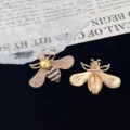 Detailed shot of rhinestone pearl bee brooch, exquisite gold crystal insect pin back view. - White Pearl Head Style (R696)