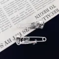 Gothic punk skull safety pin detail showing intricate skeletal design and vintage silver texture. - Silver Skull Pin (R200) / Silver