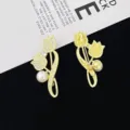 Close-up detail of a golden rhinestone tulip brooch with pearl accent, elegant suit accessory. - Golden Tulip Style (R821) / Gold